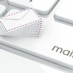 A keyboard with a mail button and small envelopes on top.