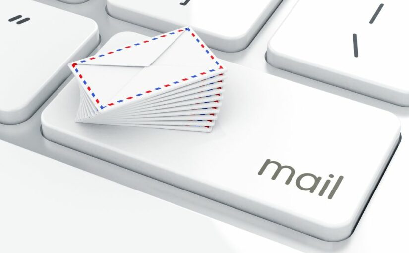 A keyboard with a mail button and small envelopes on top.