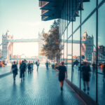 business people, modern buildings and Tower Bridge, London, UK