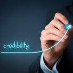 Business professional illustrating the growth of business credibility with an upward trend line, representing trust, reputation, professionalism, and long-term business success.