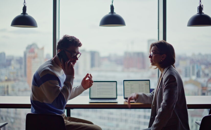 Business professionals discussing growth opportunities and customer engagement in a modern workspace environment.