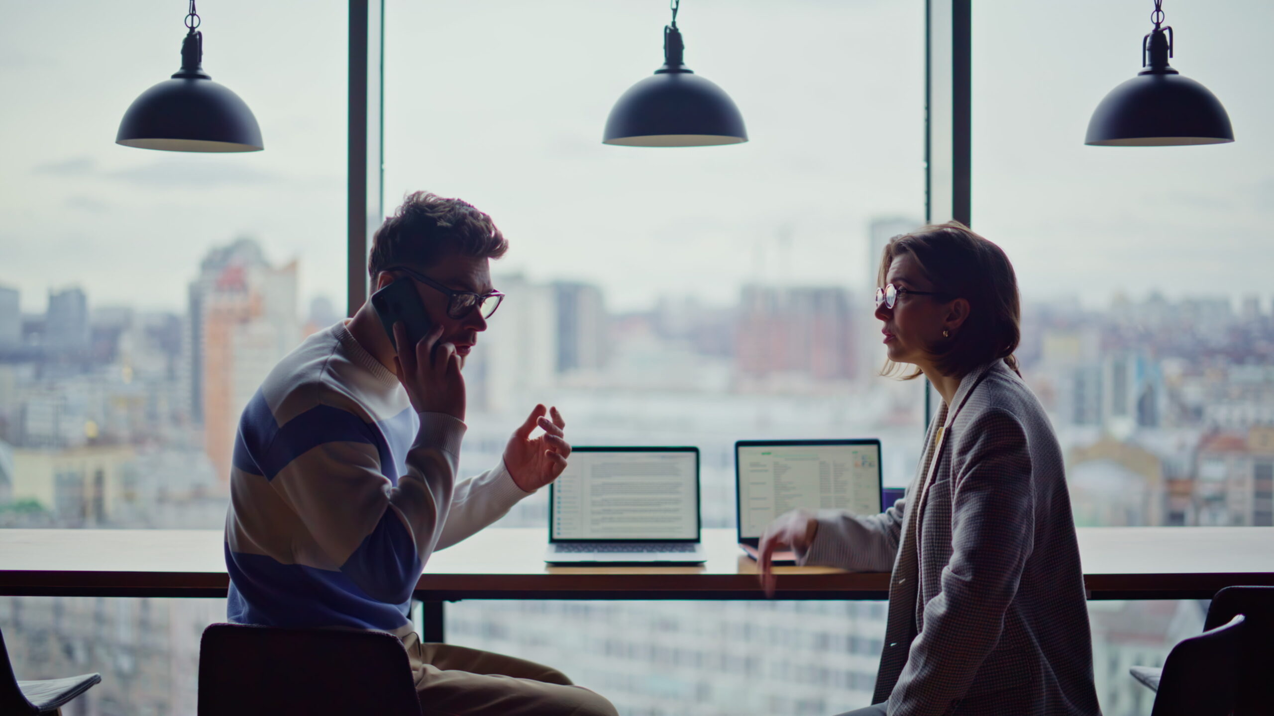 Business professionals discussing growth opportunities and customer engagement in a modern workspace environment.